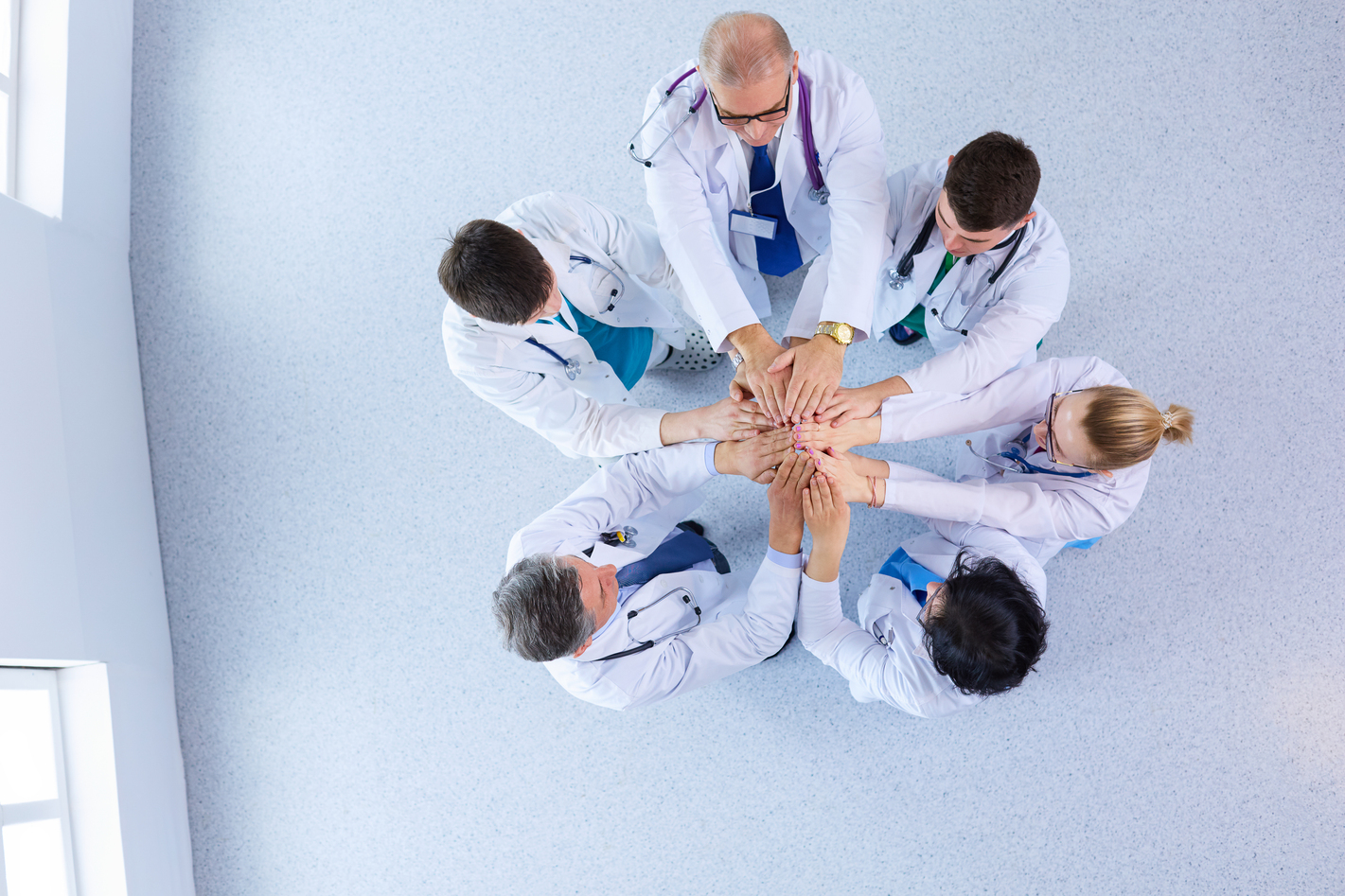 Medical team sitting and discussing at table, top view