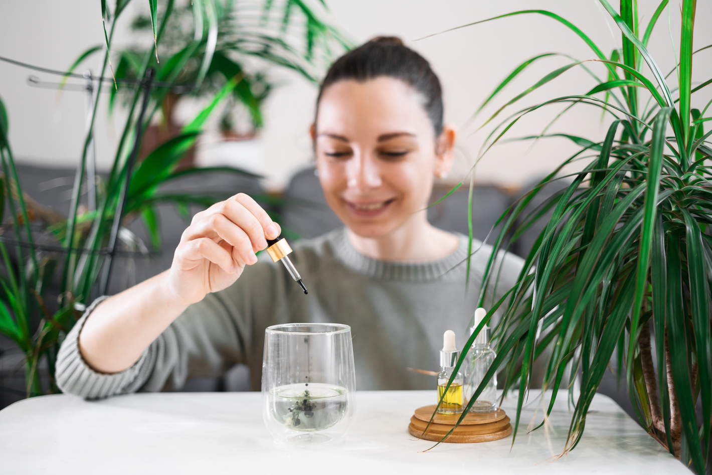 Woman drinking glass with Chlorophyll water, antioxidant beverage. Healthy lifestyle